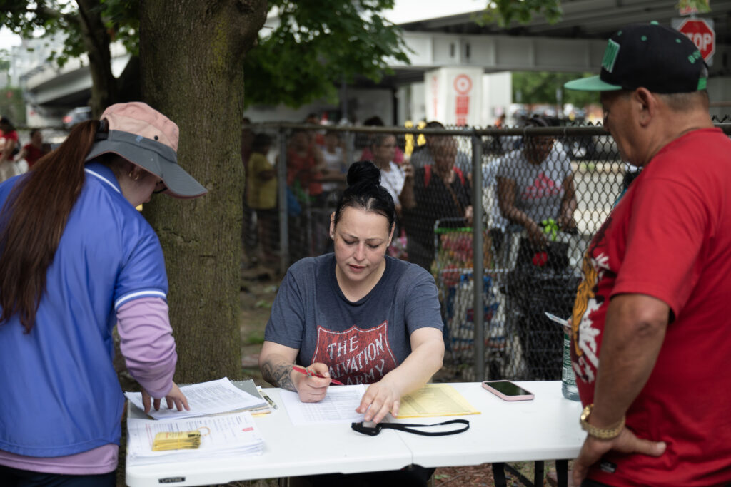 The Chelsea Corps registers people who get help from its food pantry.