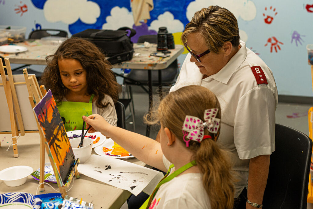 Captain BettyEllen Barrett helps the kids paint and sometimes joins in.